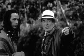 Keanu Reeves receiving direction from director Bernardo Bertolucci